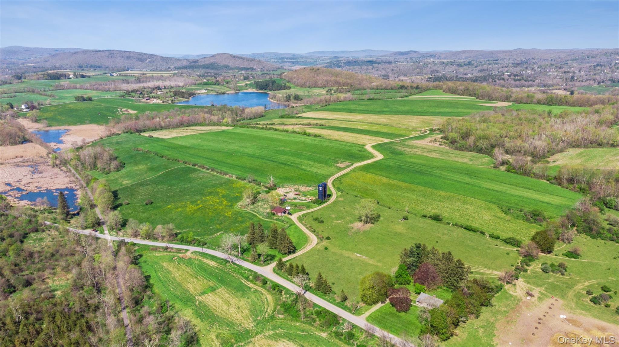 156 Sharon Station Road Amenia, NY 12501 - Photo 1 of 18 a view of a lush green hillside and houses