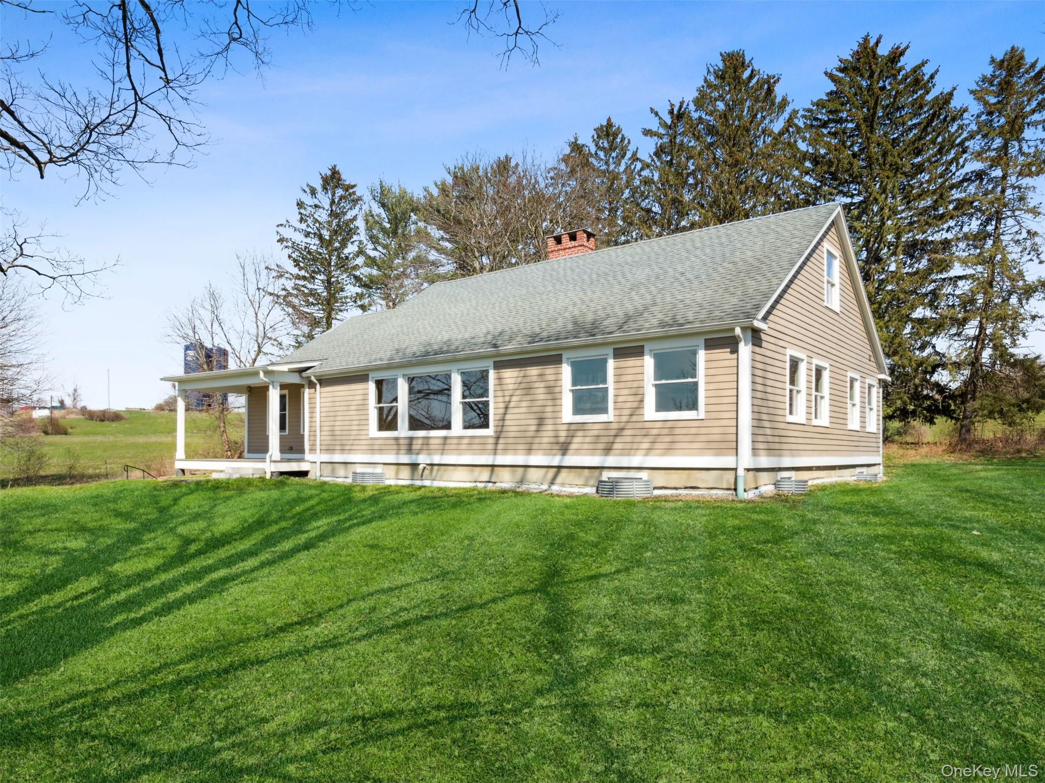 156 Sharon Station Road Amenia, NY 12501 - Photo 17 of 18 a front view of a house with a garden