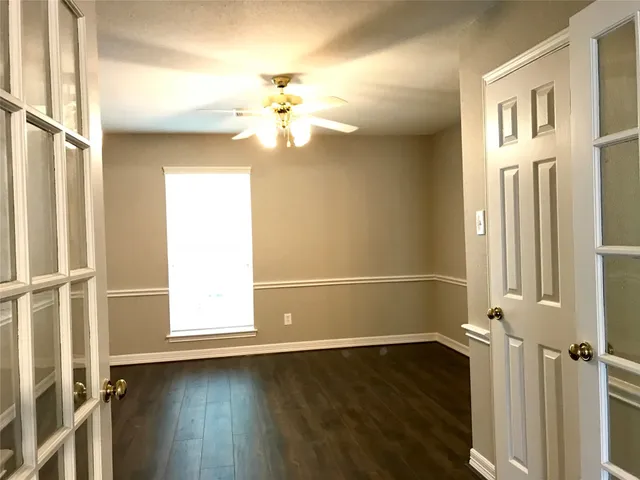 wooden floor in an empty room with a window