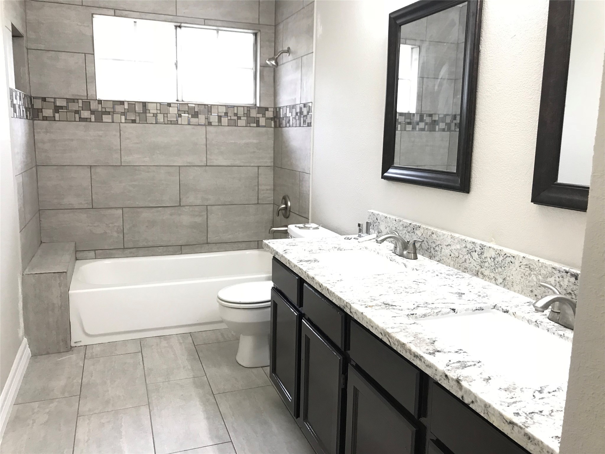 5722 Fort Sumter Lane Houston, TX 77084 - Photo 16 of 22 a bathroom with a granite countertop sink a toilet and bathtub