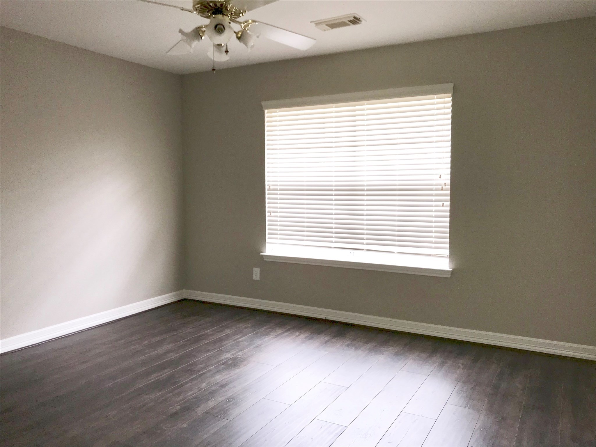 5722 Fort Sumter Lane Houston, TX 77084 - Photo 18 of 22 a view of an empty room with a window and wooden floor