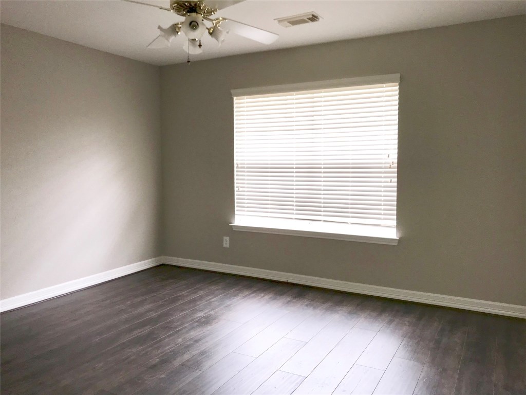 5722 Fort Sumter Lane Houston, TX 77084 - Photo 18 of 22 a view of an empty room with a window and wooden floor
