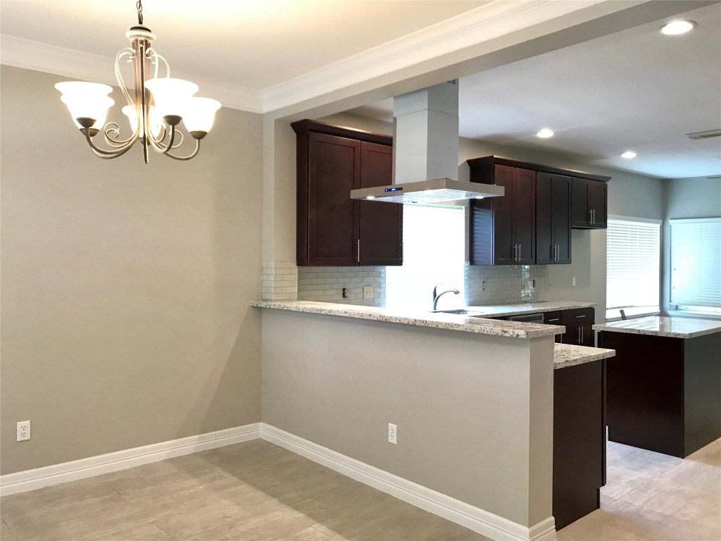5722 Fort Sumter Lane Houston, TX 77084 - Photo 4 of 22 a view of a kitchen with a sink and chandelier