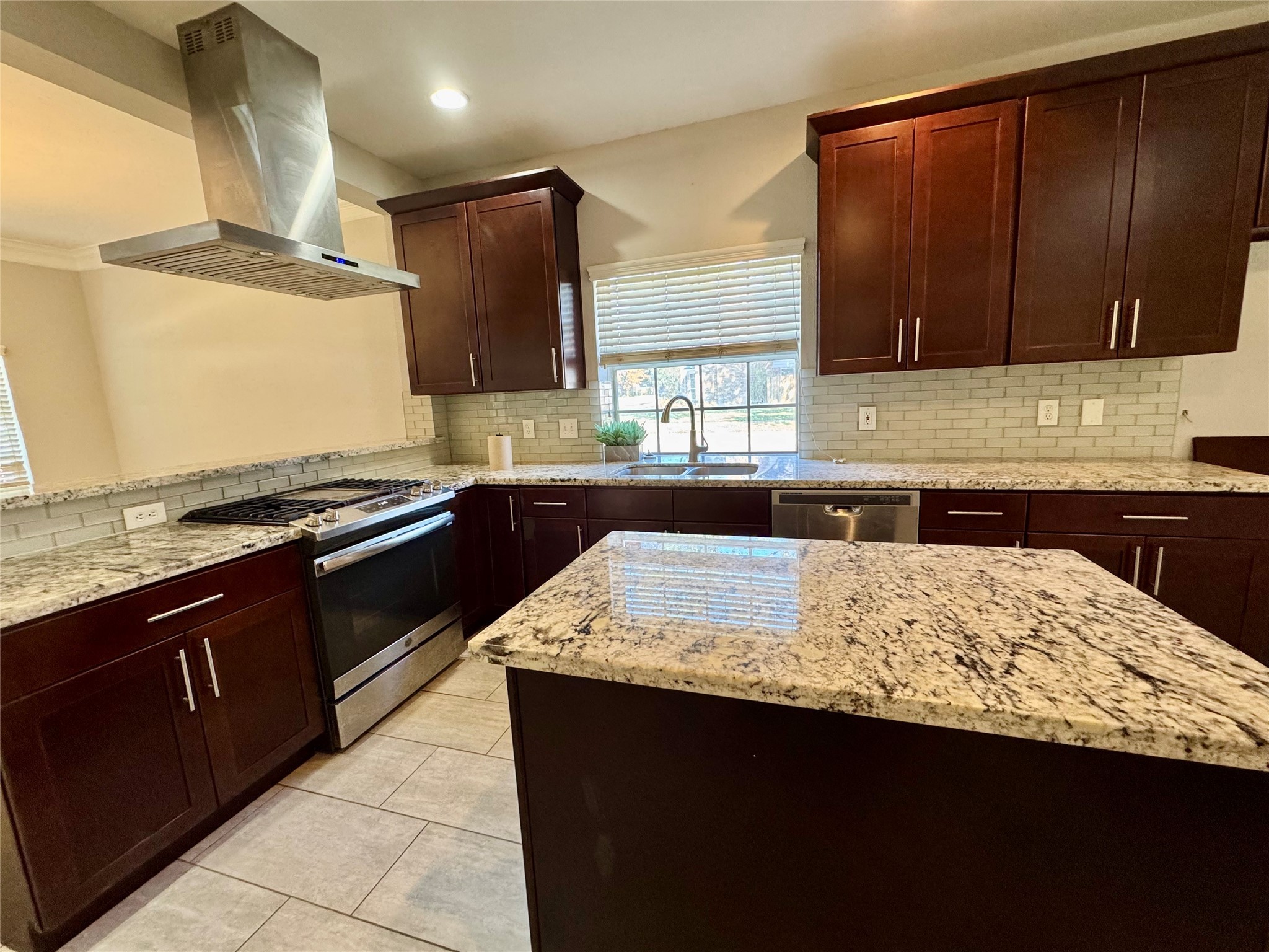5722 Fort Sumter Lane Houston, TX 77084 - Photo 5 of 22 a kitchen with kitchen island granite countertop a sink stove and refrigerator