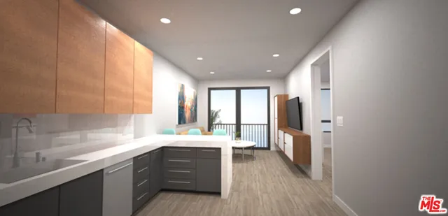 a large kitchen with a large counter top a sink a window and stainless steel appliances