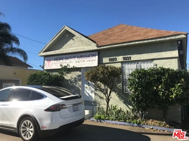 a front view of a house with parking area