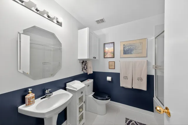 a bathroom with a toilet a sink and bathtub