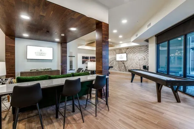 a dining room with furniture and a wooden floor