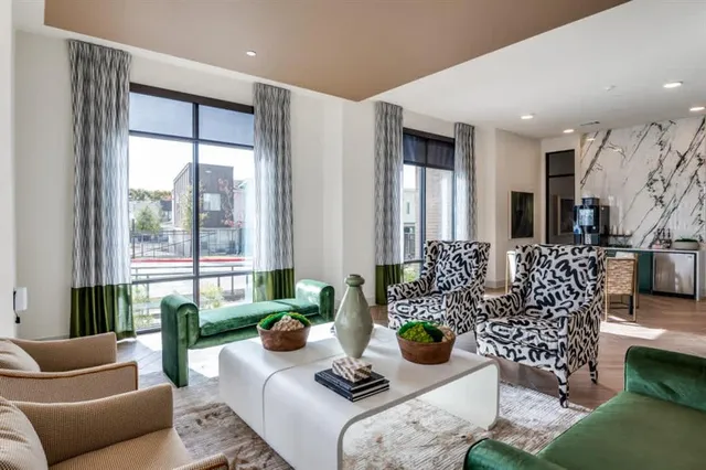 a living room with furniture and floor to ceiling windows