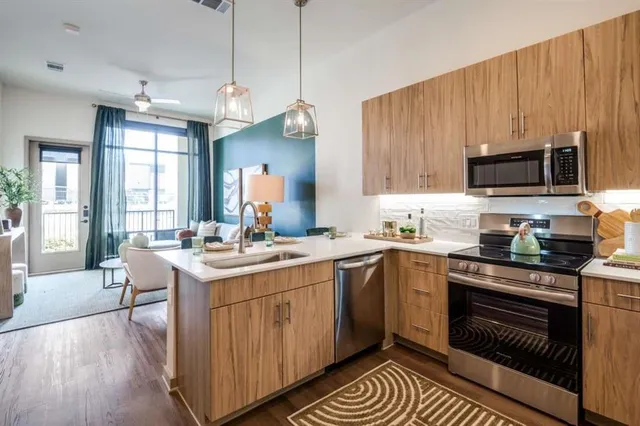 a kitchen with a sink stove and microwave