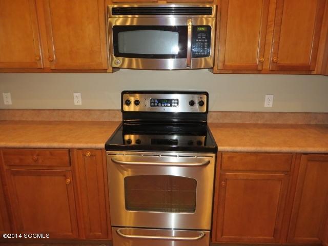 330 Ambrosia Court Rio Rico, AZ 85648 - Photo 15 of 37 a stove top oven sitting inside of a kitchen