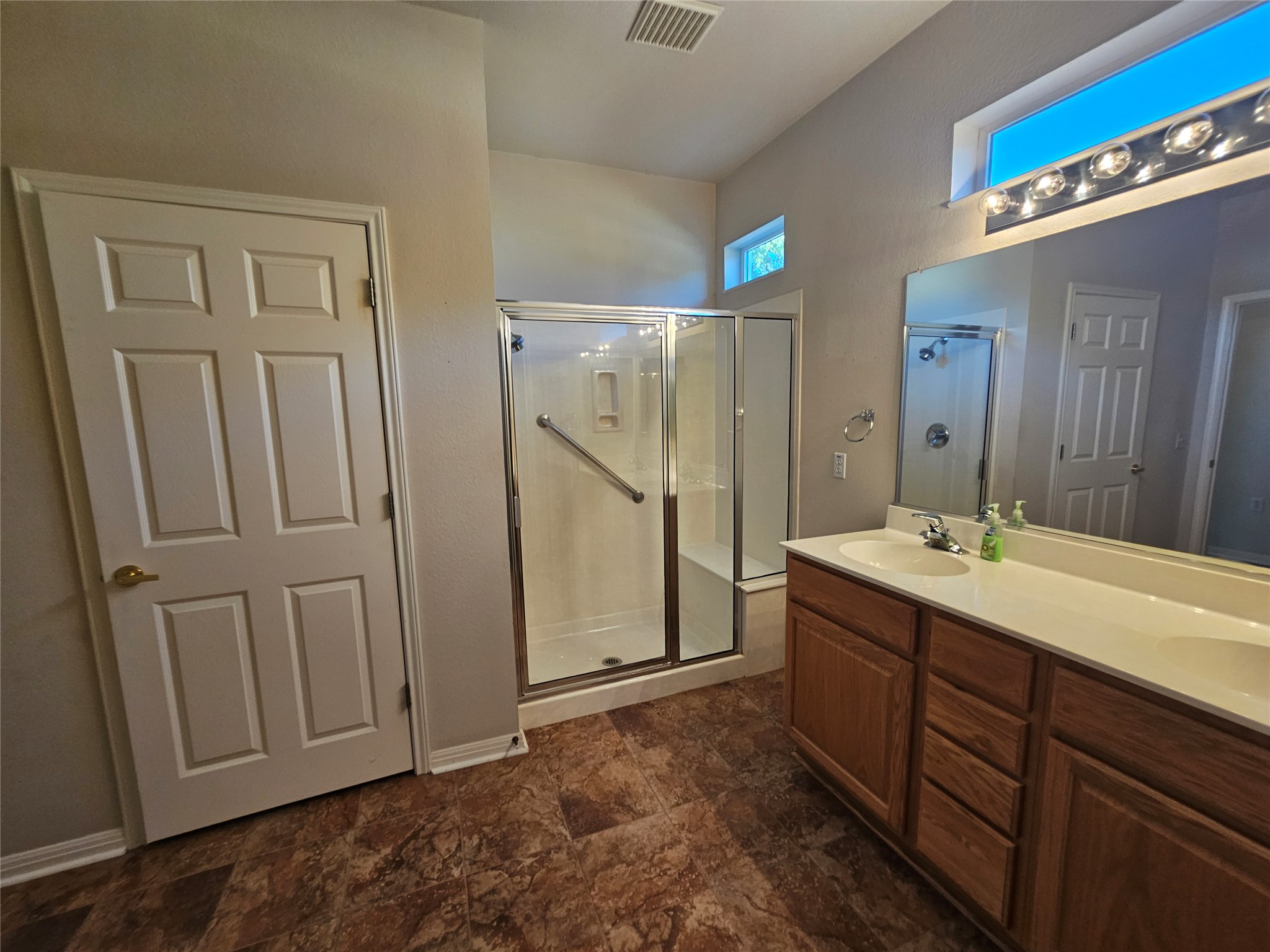 211 Red Poppy Trail Georgetown, TX 78633 - Photo 12 of 35 a bathroom with a double vanity sink and mirror