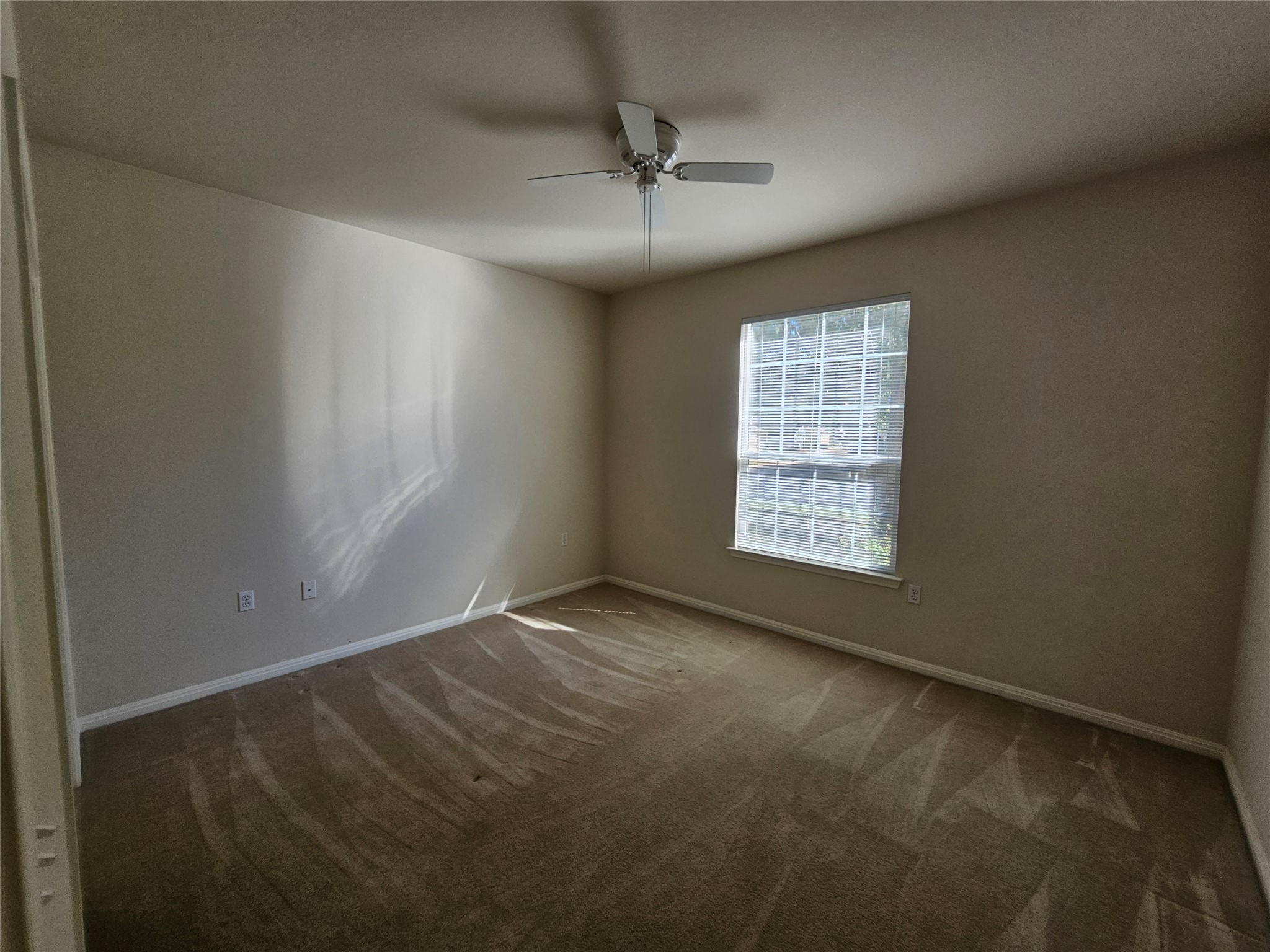 211 Red Poppy Trail Georgetown, TX 78633 - Photo 15 of 35 an empty room with a window and a ceiling fan
