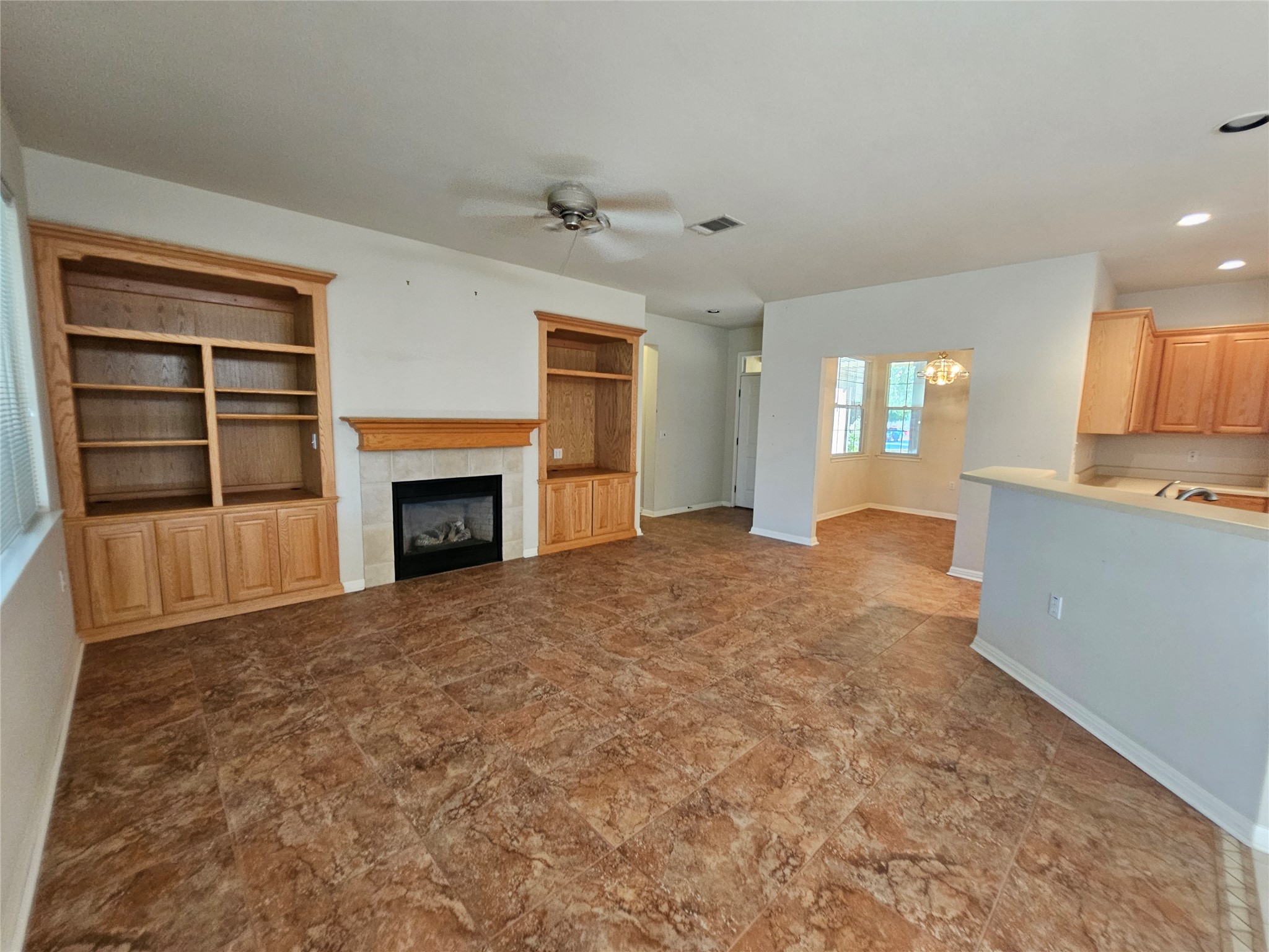 211 Red Poppy Trail Georgetown, TX 78633 - Photo 22 of 35 a view of an empty room with a fireplace and a window