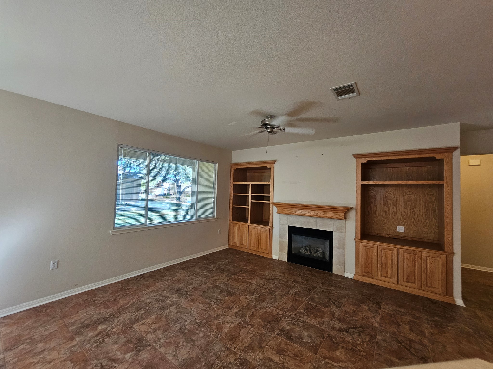 211 Red Poppy Trail Georgetown, TX 78633 - Photo 28 of 35 a view of empty room with a fireplace