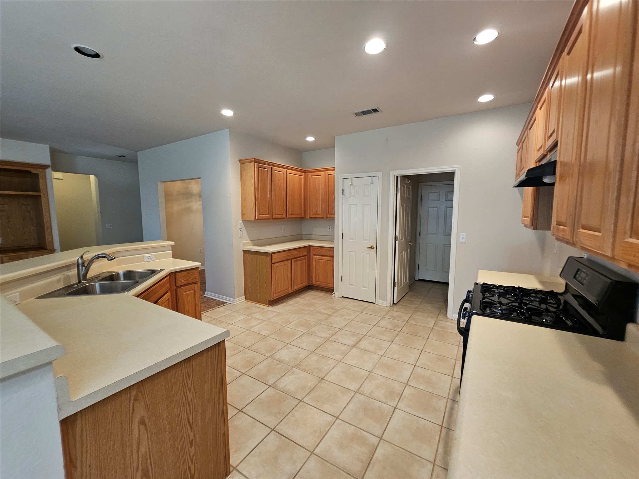 211 Red Poppy Trail Georgetown, TX 78633 - Photo 30 of 35 a kitchen with stainless steel appliances granite countertop a sink stove and refrigerator