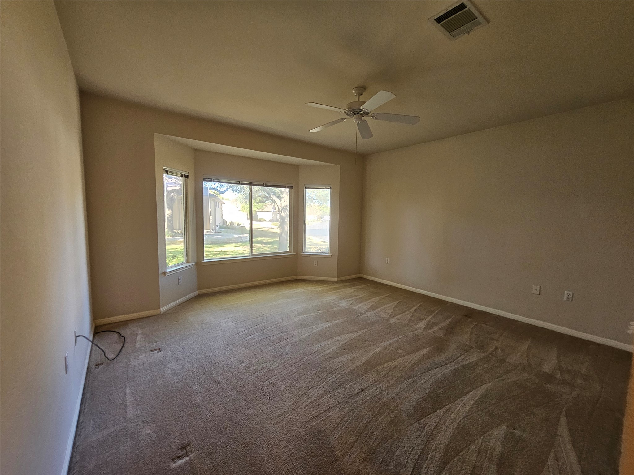 211 Red Poppy Trail Georgetown, TX 78633 - Photo 5 of 35 an empty room with windows and fan