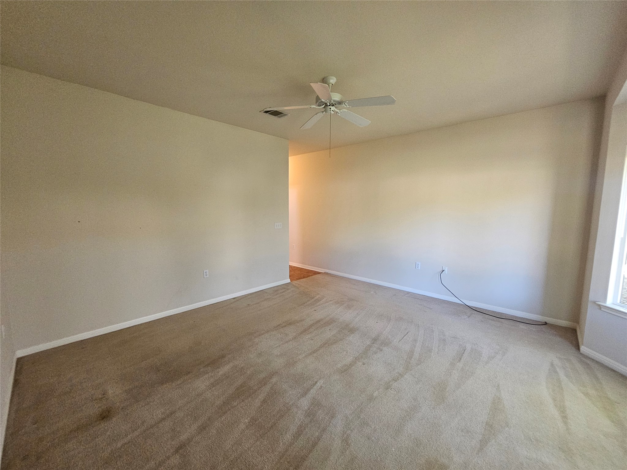 211 Red Poppy Trail Georgetown, TX 78633 - Photo 8 of 35 an empty room with a ceiling fan and window