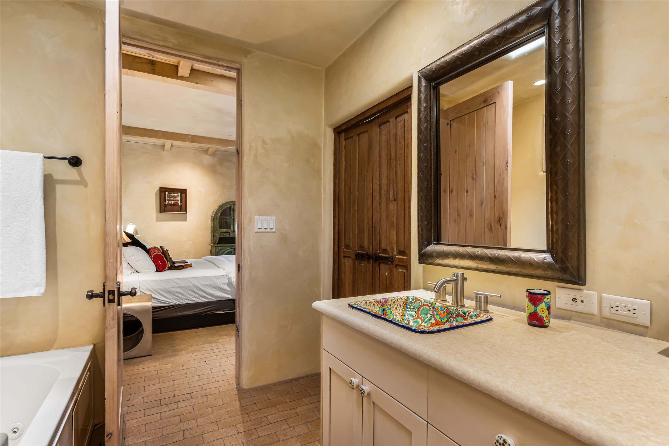 1 Cerro Gordo Road, Unit B Santa Fe, NM 87501 - Photo 15 of 25 Primary bath of travertine marble with tub and separate shower and walk-in closet.