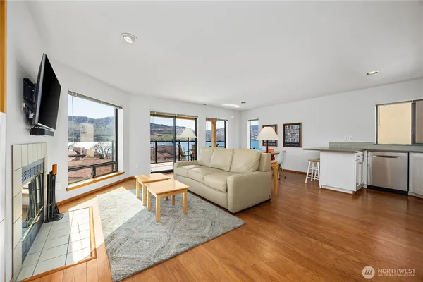 a living room with fireplace furniture and a flat screen tv