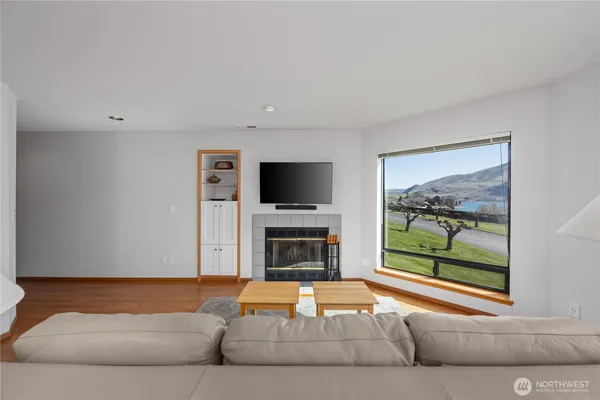 a living room with fireplace furniture and a flat screen tv