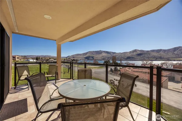 a view of a chairs and table in patio
