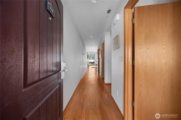 a view of hallway with wooden floor