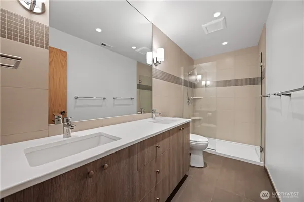 a bathroom with a sink double vanity and a mirror