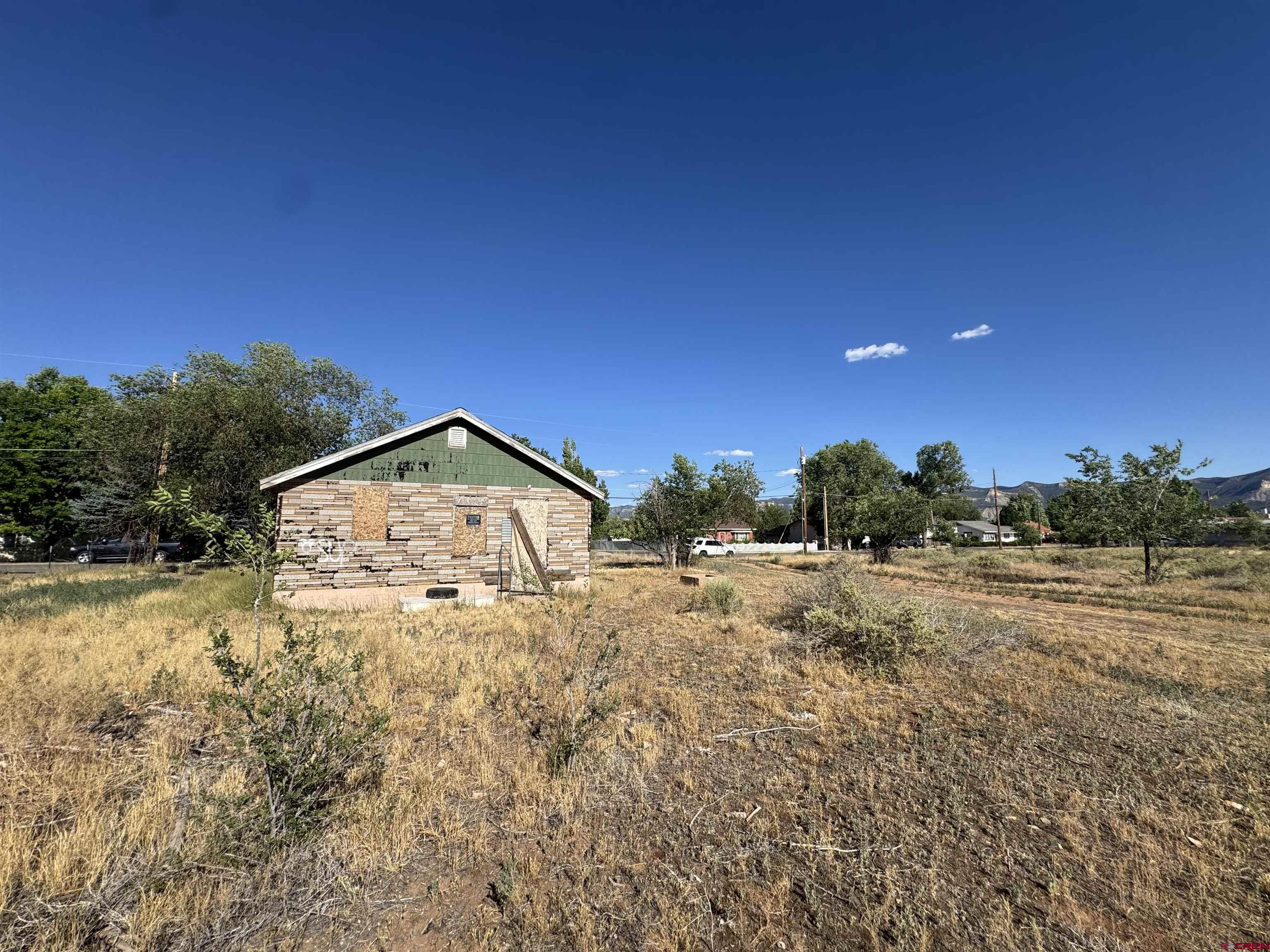 821 South Chestnut Street Cortez, CO 81321 - Photo 4 of 9 a view of a yard with a house