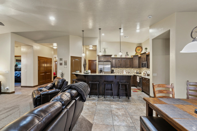 210 Talon Court Ivins, UT 84738 - Photo 16 of 60 Living room featuring a high ceiling and light tile patterned flooring