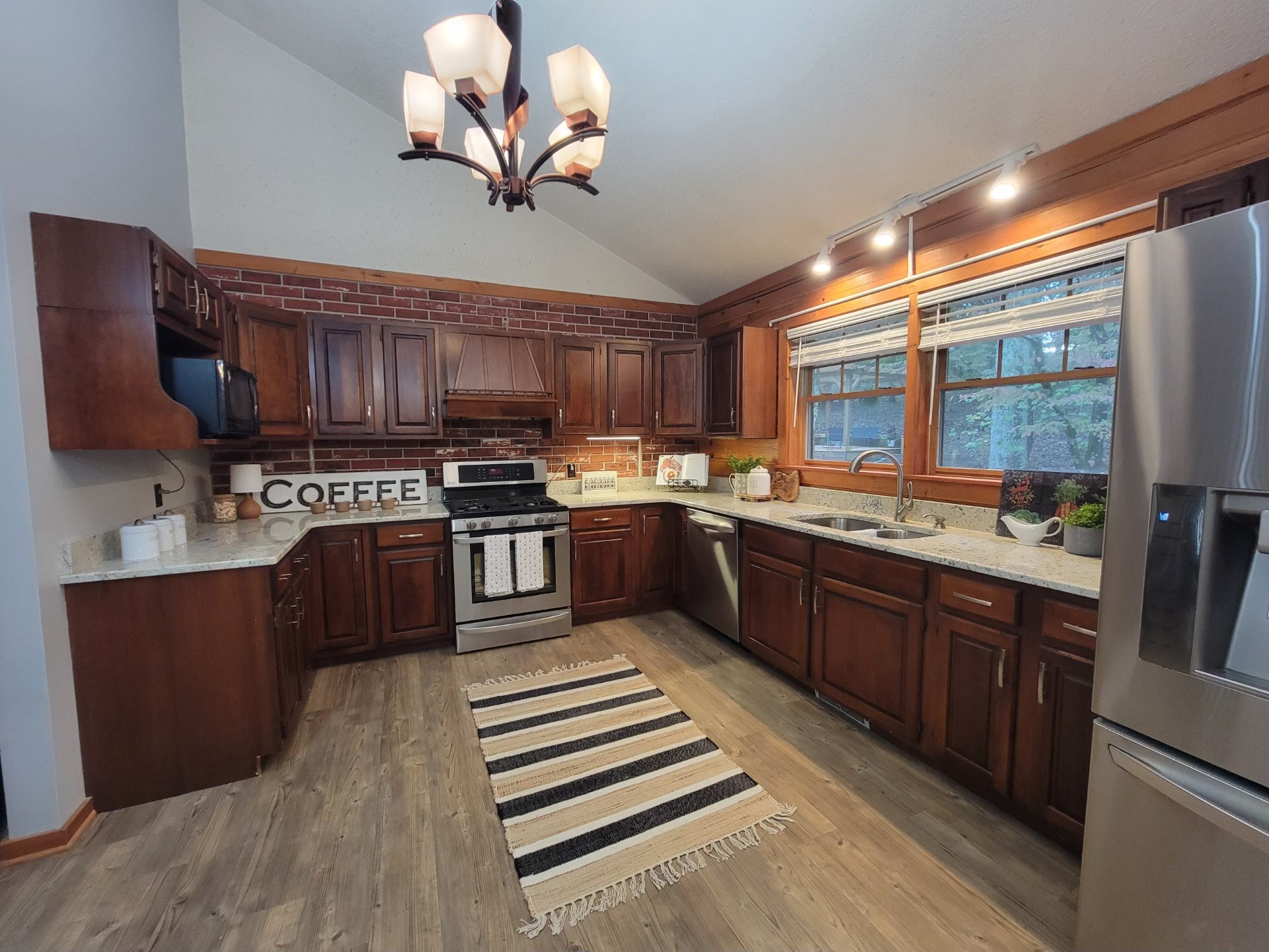 1006 Sullivan Drive White Bluff, TN 37187 - Photo 15 of 46 a kitchen with stainless steel appliances granite countertop a stove a sink dishwasher and a microwave oven with cabinets