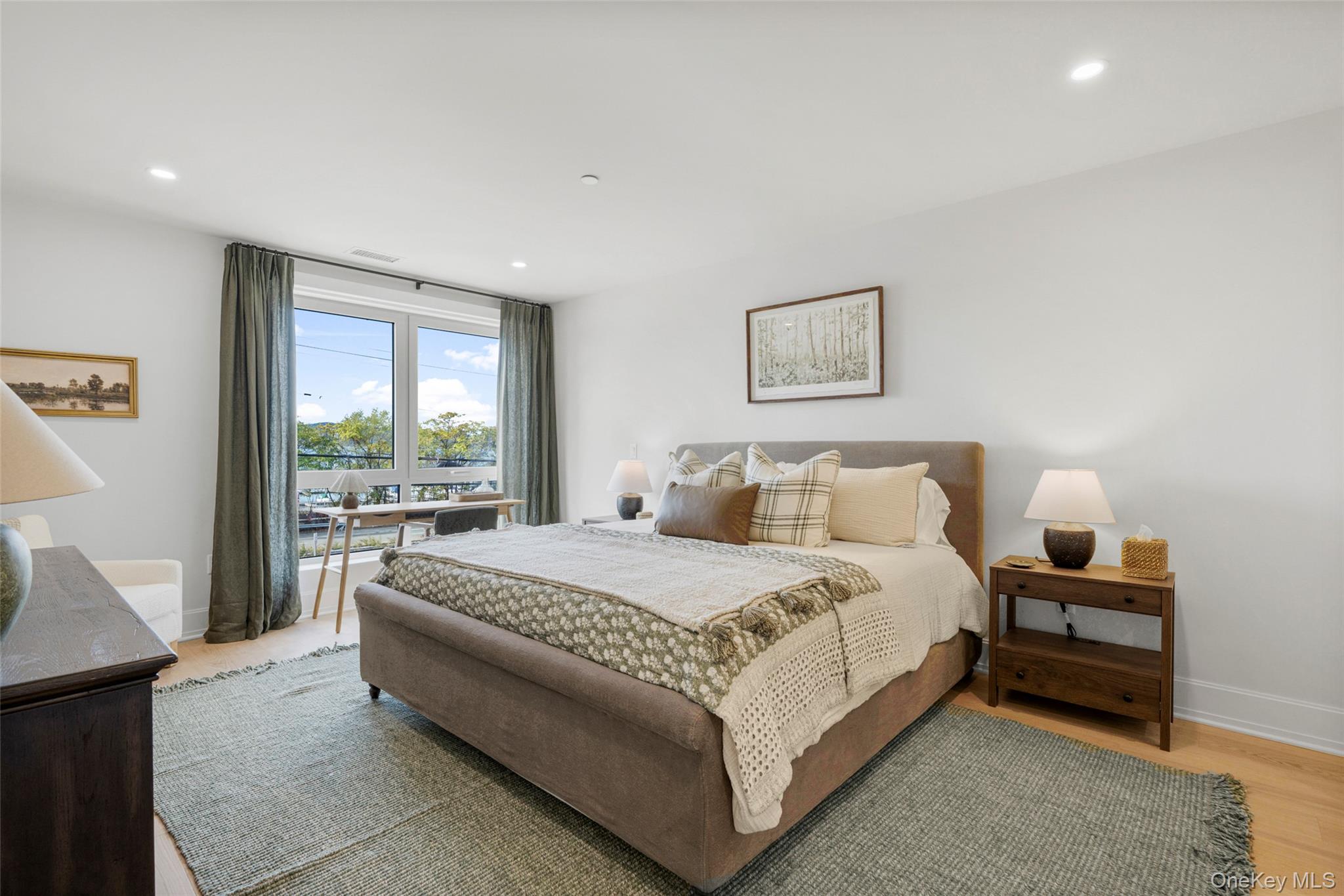 25 South Riverside Avenue, Unit 309 Croton-on-Hudson, NY 10520 - Photo 14 of 26 a spacious bedroom with a bed and a couch