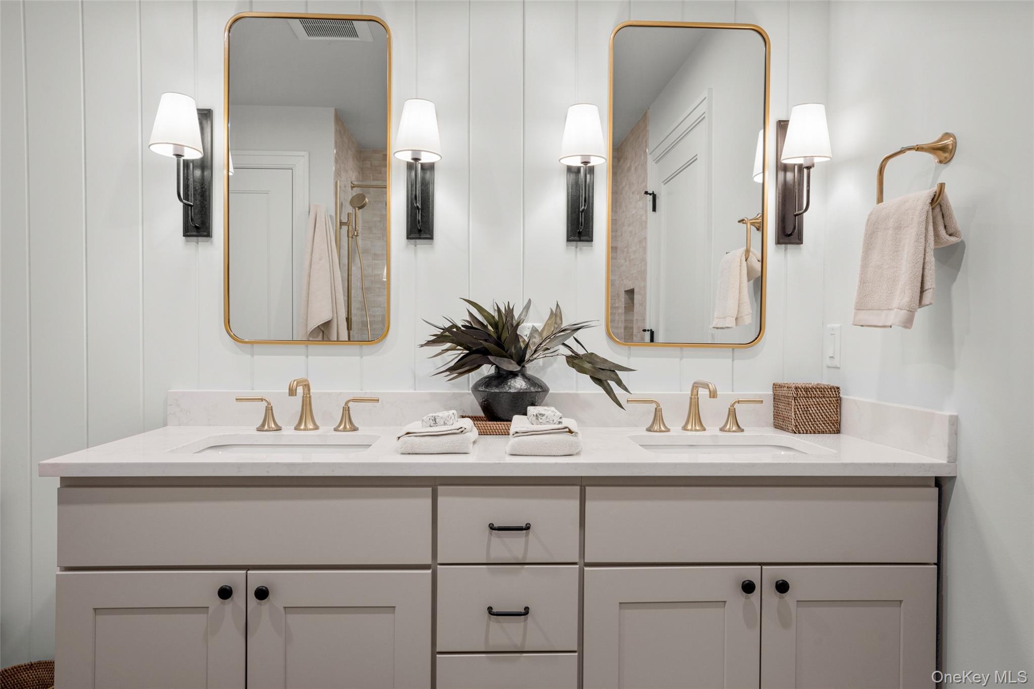 25 South Riverside Avenue, Unit 309 Croton-on-Hudson, NY 10520 - Photo 18 of 26 a bathroom with double vanity sinks and a mirror