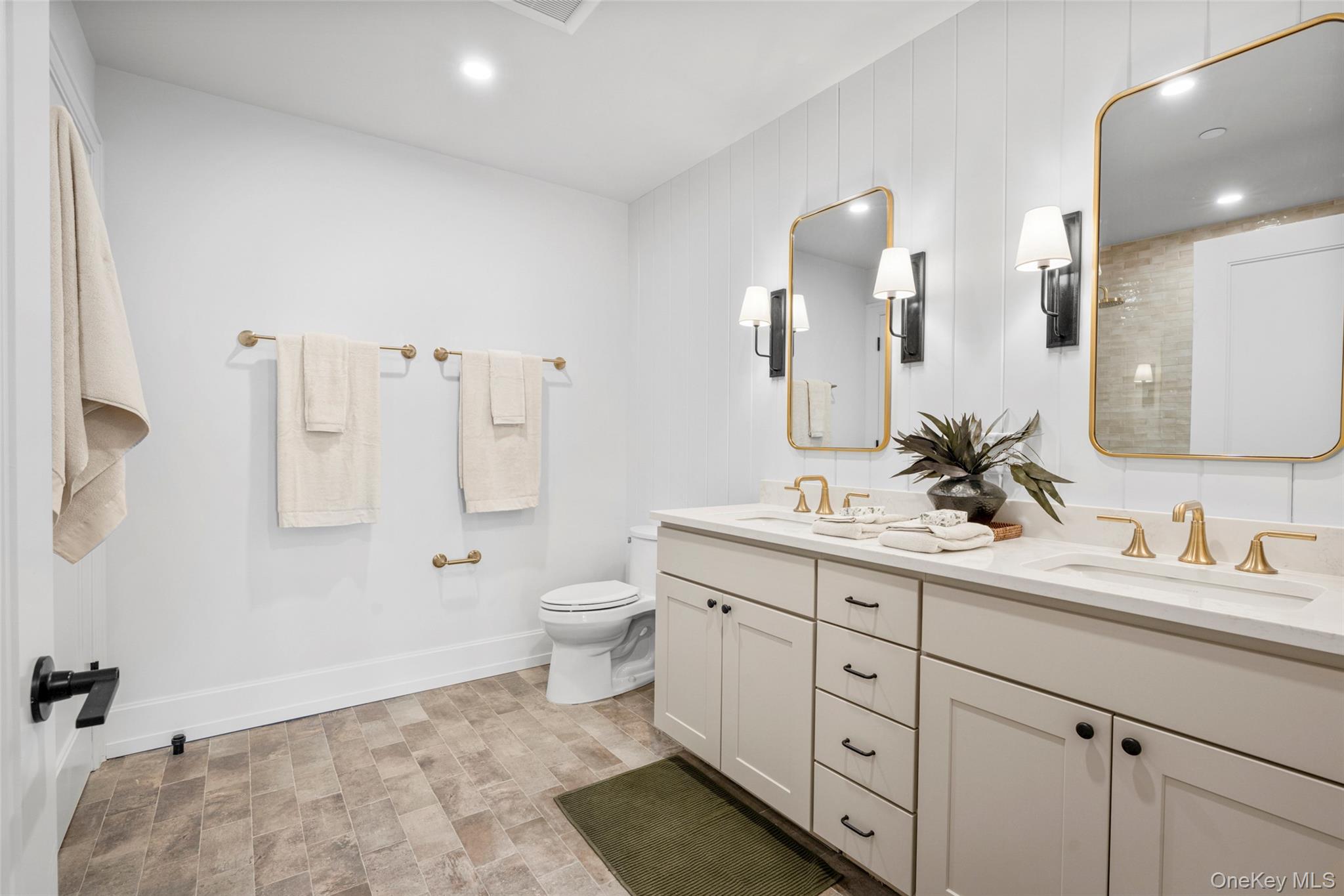 25 South Riverside Avenue, Unit 309 Croton-on-Hudson, NY 10520 - Photo 19 of 26 a bathroom with a double vanity sink toilet and mirror