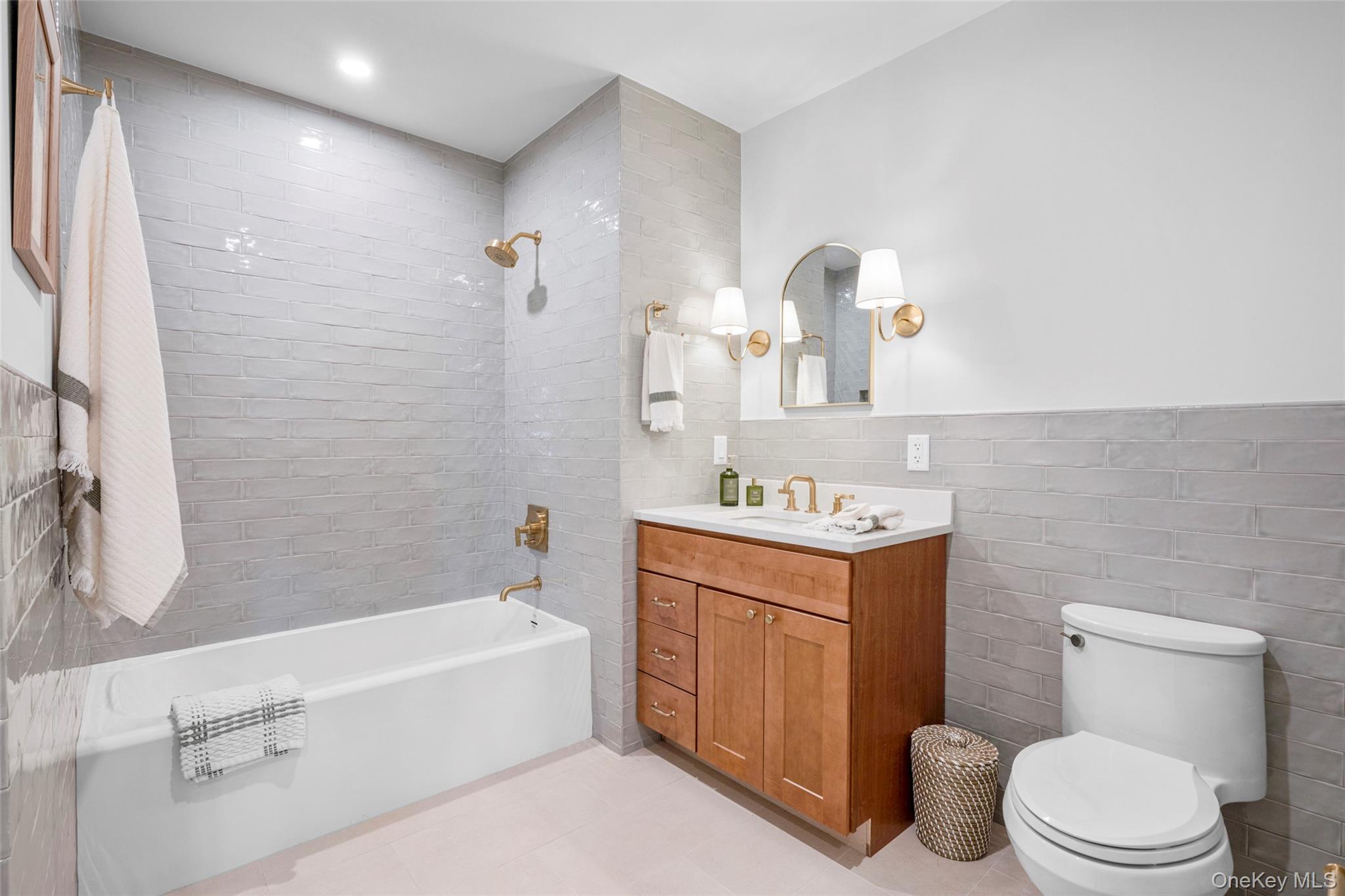 25 South Riverside Avenue, Unit 309 Croton-on-Hudson, NY 10520 - Photo 23 of 26 a bathroom with a sink toilet vanity and bathtub
