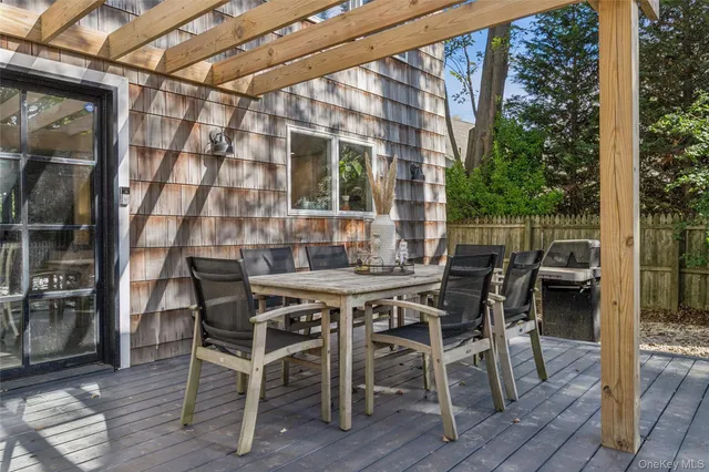 a view of an outside dining space with furniture window and wooden floor