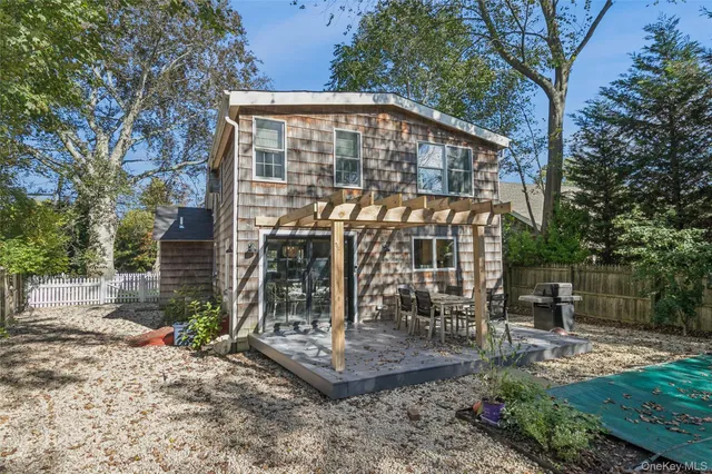 a view of a house with backyard and sitting area