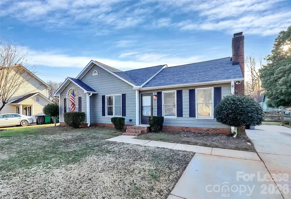 a front view of a house with a yard and outdoor seating