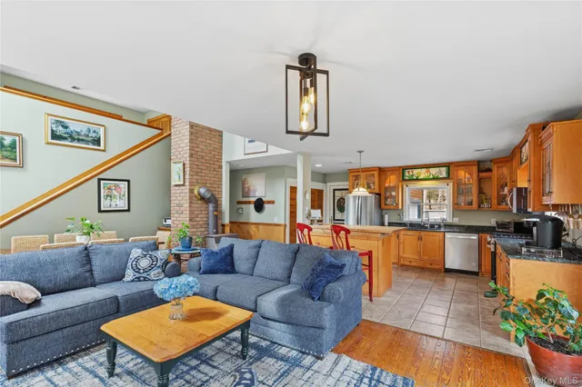 a living room with furniture a fireplace and a potted plant
