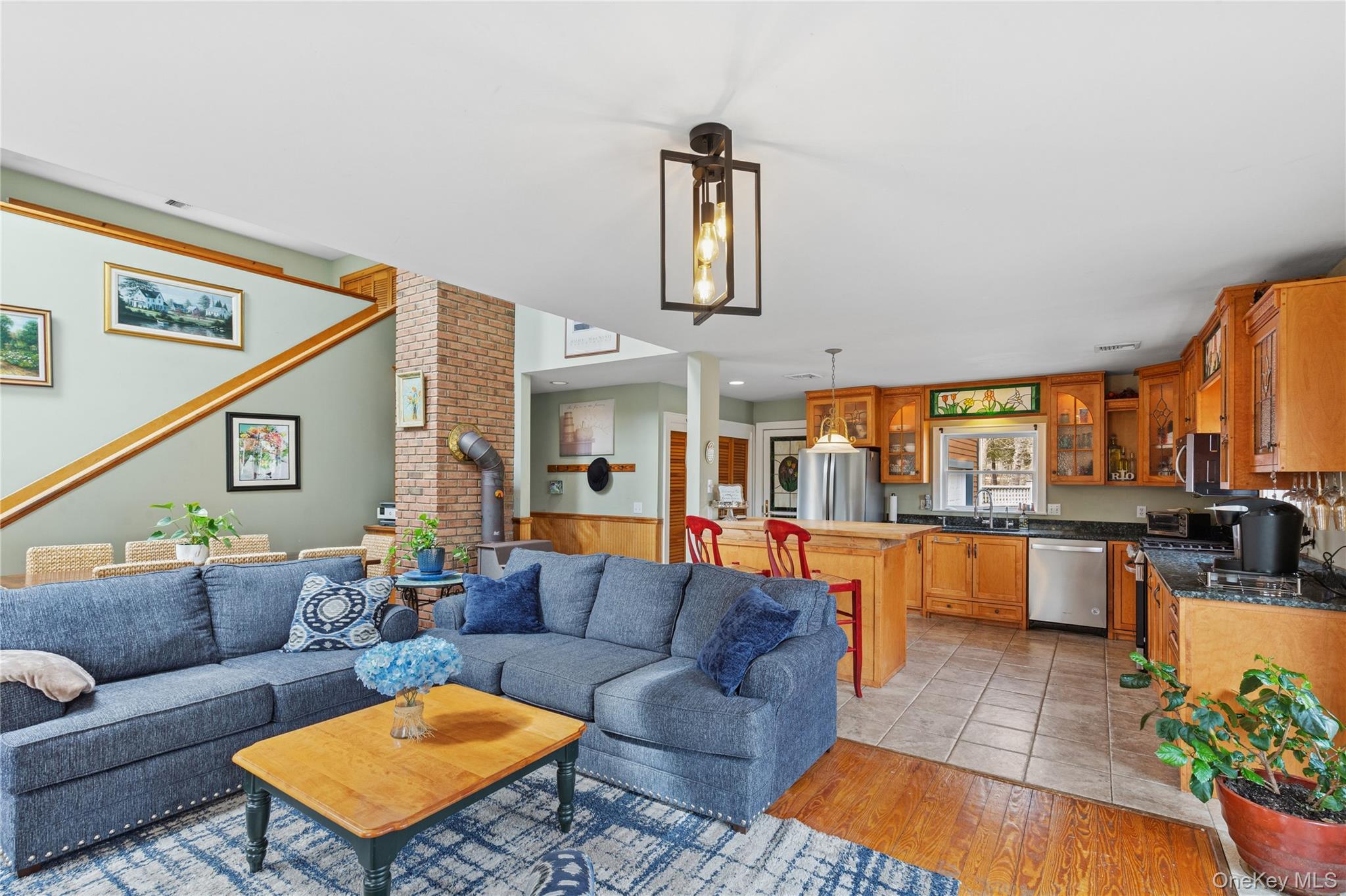 1745 Bay View Avenue Mattituck, NY 11952 - Photo 12 of 37 a living room with furniture a fireplace and a potted plant