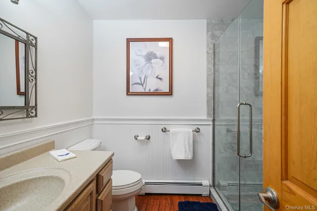 a bathroom with a granite countertop sink toilet and shower