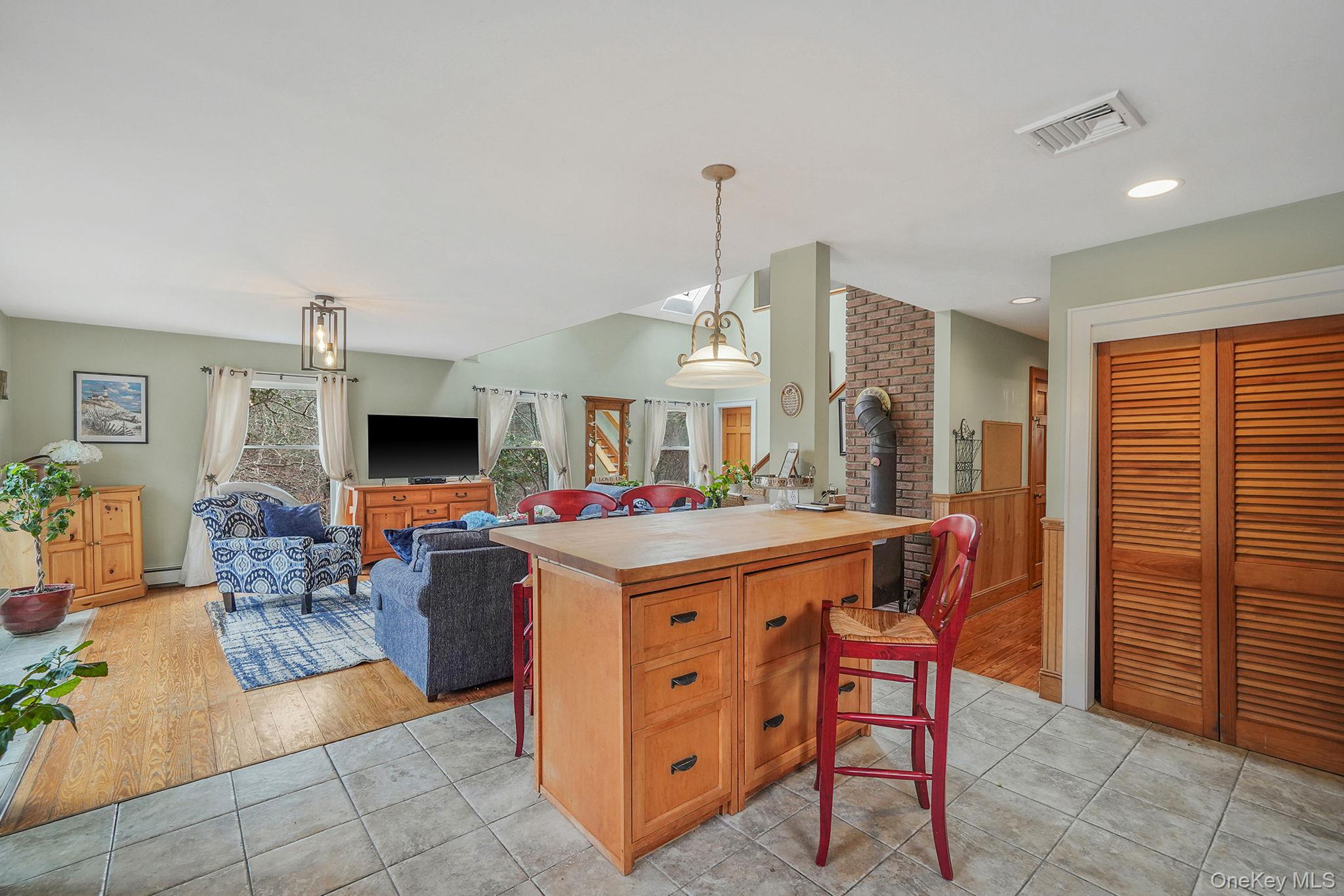 1745 Bay View Avenue Mattituck, NY 11952 - Photo 15 of 37 a living room with furniture a flat screen tv and a refrigerator