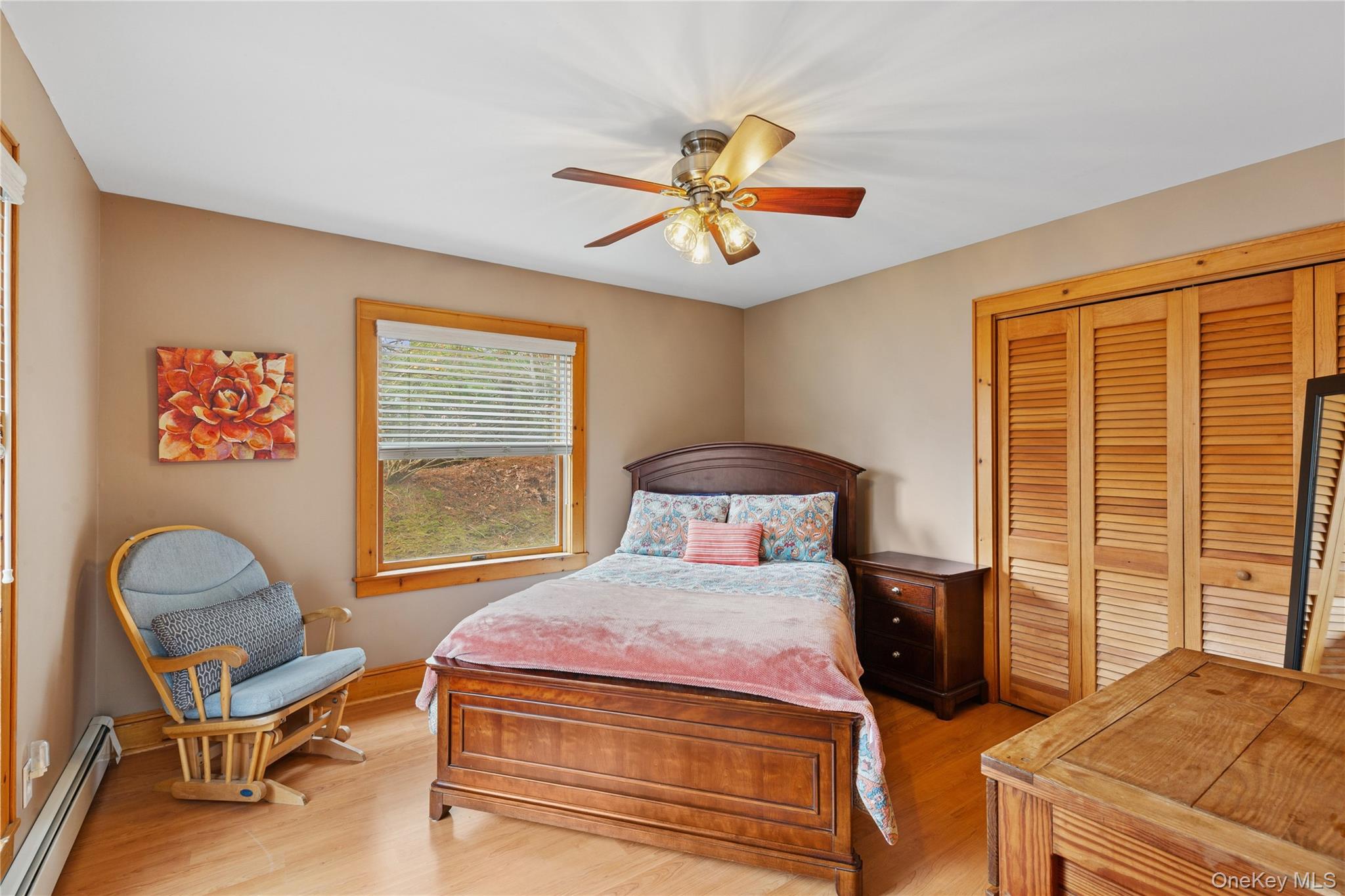 1745 Bay View Avenue Mattituck, NY 11952 - Photo 17 of 37 a bedroom with a bed and a chandelier