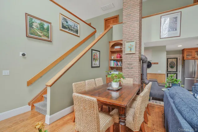 a dining room with furniture and wooden floor