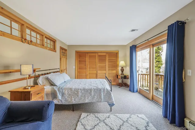 a bedroom with a bed and glass window