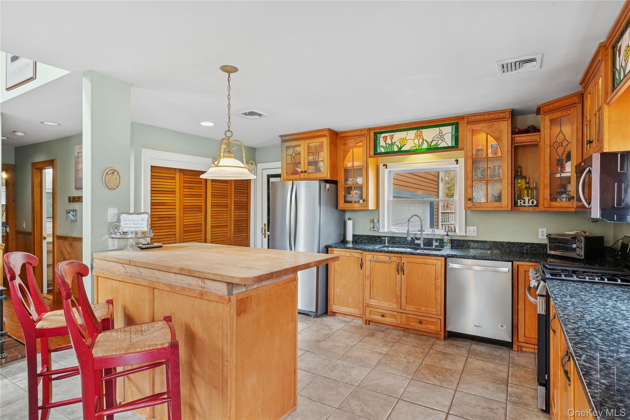 1745 Bay View Avenue Mattituck, NY 11952 - Photo 9 of 37 a kitchen with stainless steel appliances granite countertop counter space a sink and cabinets