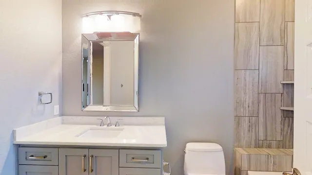 a bathroom with a sink vanity and a mirror
