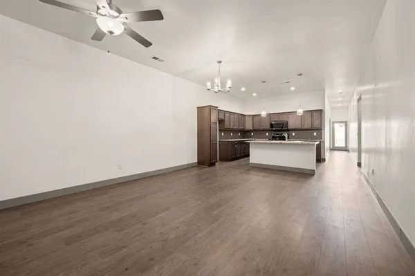 a view of a kitchen with a sink refrigerator and cabinets