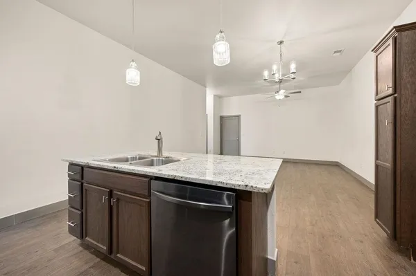 a kitchen with a sink a counter space and a window
