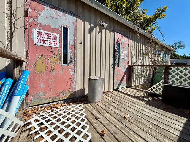 a view of a street with wooden fence
